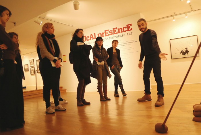 Thomas Lax, assistant curator from the Studio Museum giving an exhibition tour of Radical Presence to RU artists.